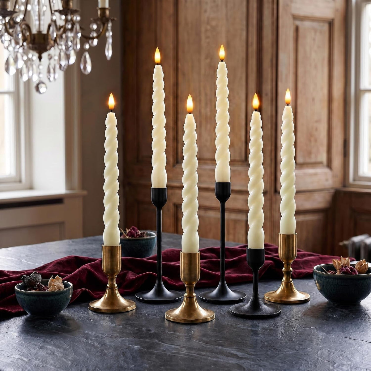 Spiral LED taper candles glowing in black and gold holders