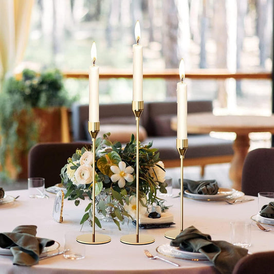 Gold tulip taper candle holders as a wedding table centrepiece