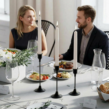 Black candle holders on a candlelit dinner for two