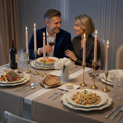 Gold bell taper candle holders on a dinner table