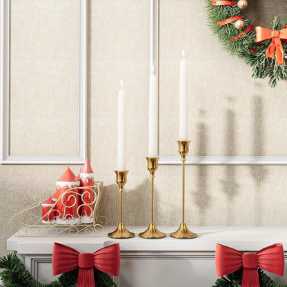 Gold bell candle holders styled on a festive mantel
